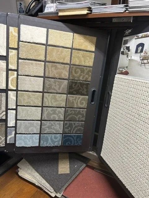 A display of carpet samples on a wooden floor