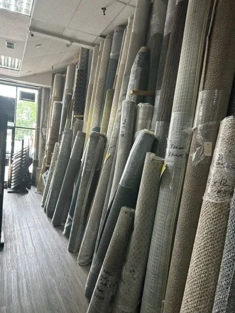 A room filled with rolls of carpet in a store.