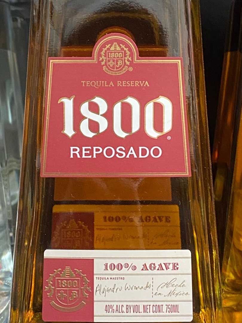 A close up of a bottle of 1800 reposado tequila