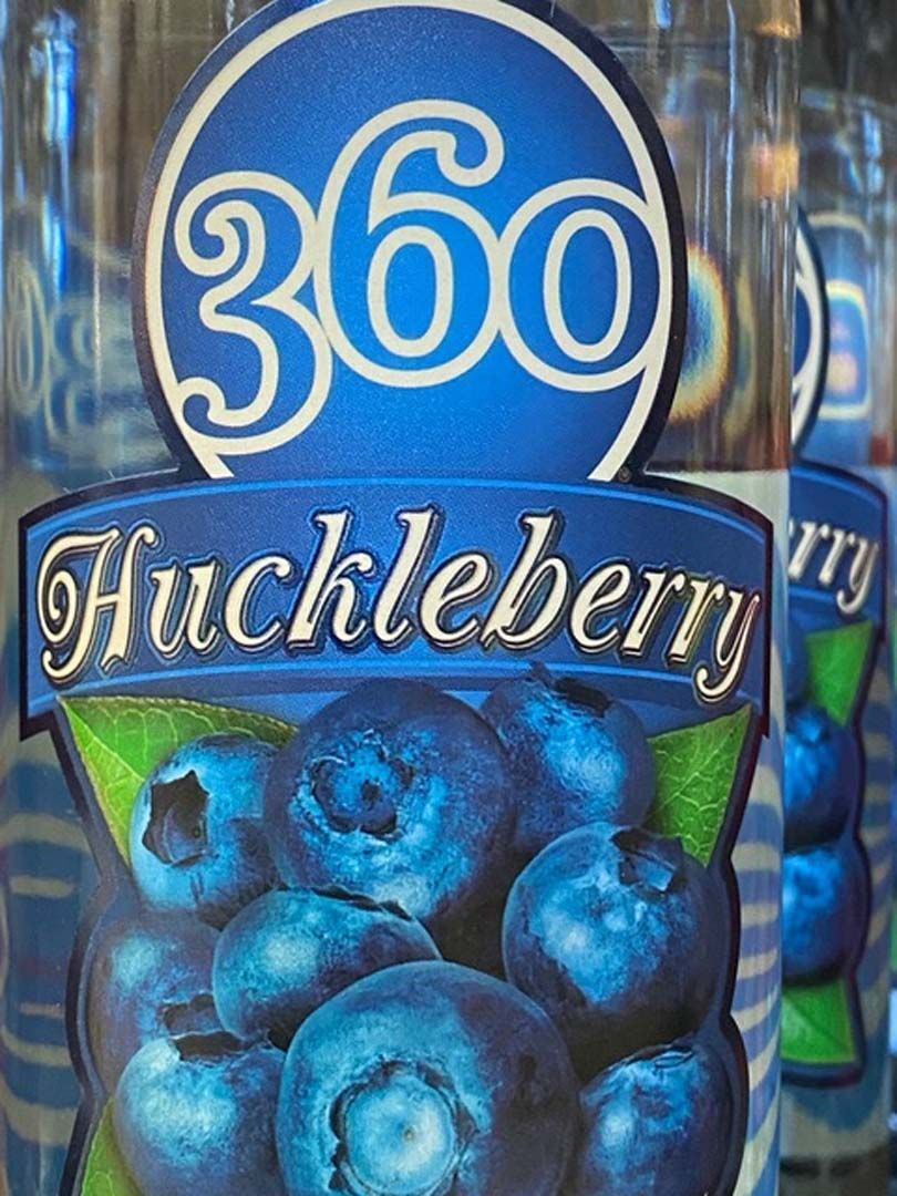 A bottle of 360 huckleberry juice with blueberries on the label