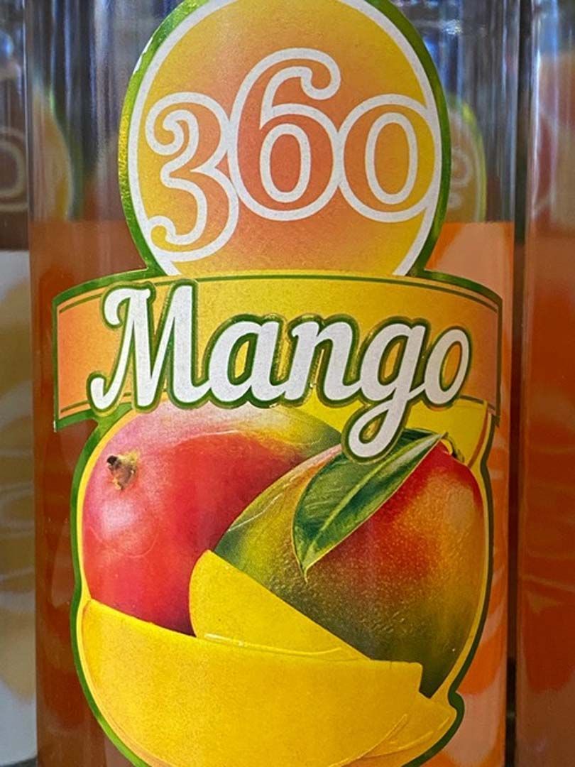 A close up of a bottle of 360 mango juice