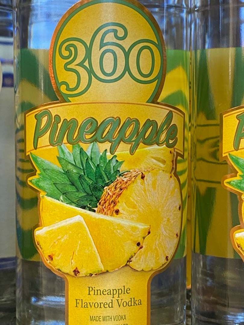 A close up of a bottle of pineapple flavored vodka