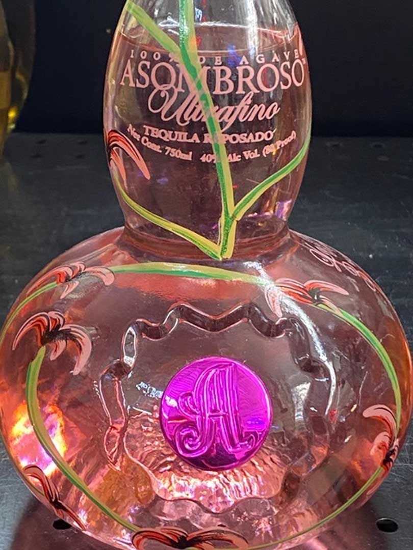 A bottle of tequila is sitting on a table.