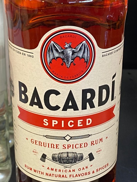 A bottle of bacardi spiced rum with a bat on the label