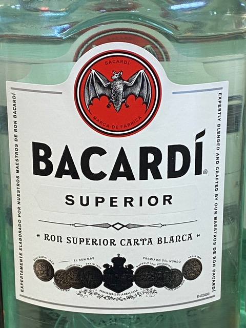 A bottle of bacardi superior has a bat on the label