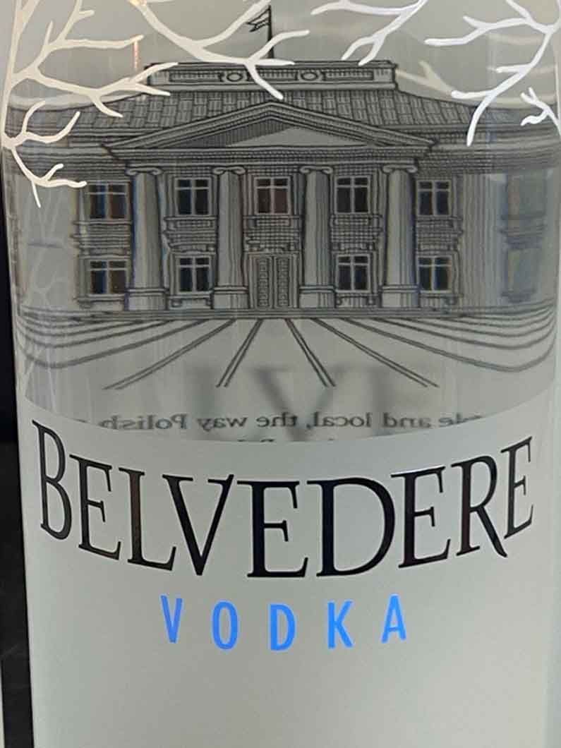 A bottle of belvedere vodka with a building on the label