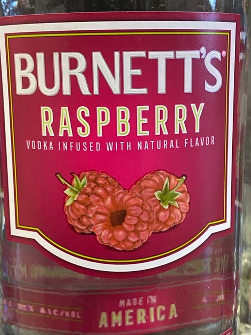 A bottle of burnett 's raspberry vodka infused with natural flavor