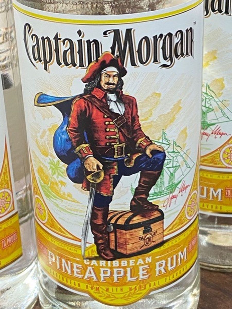 A bottle of captain morgan pineapple rum with a pirate on the label