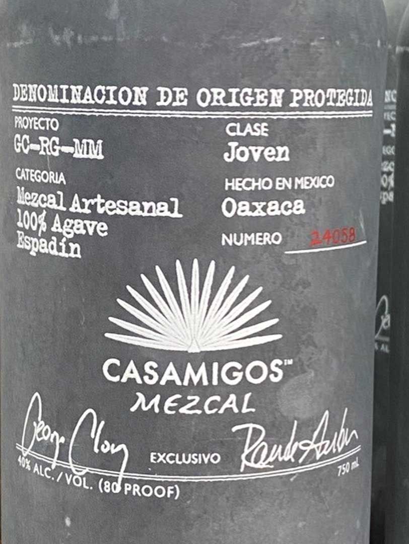 A bottle of casamigos mezcal is sitting on a table