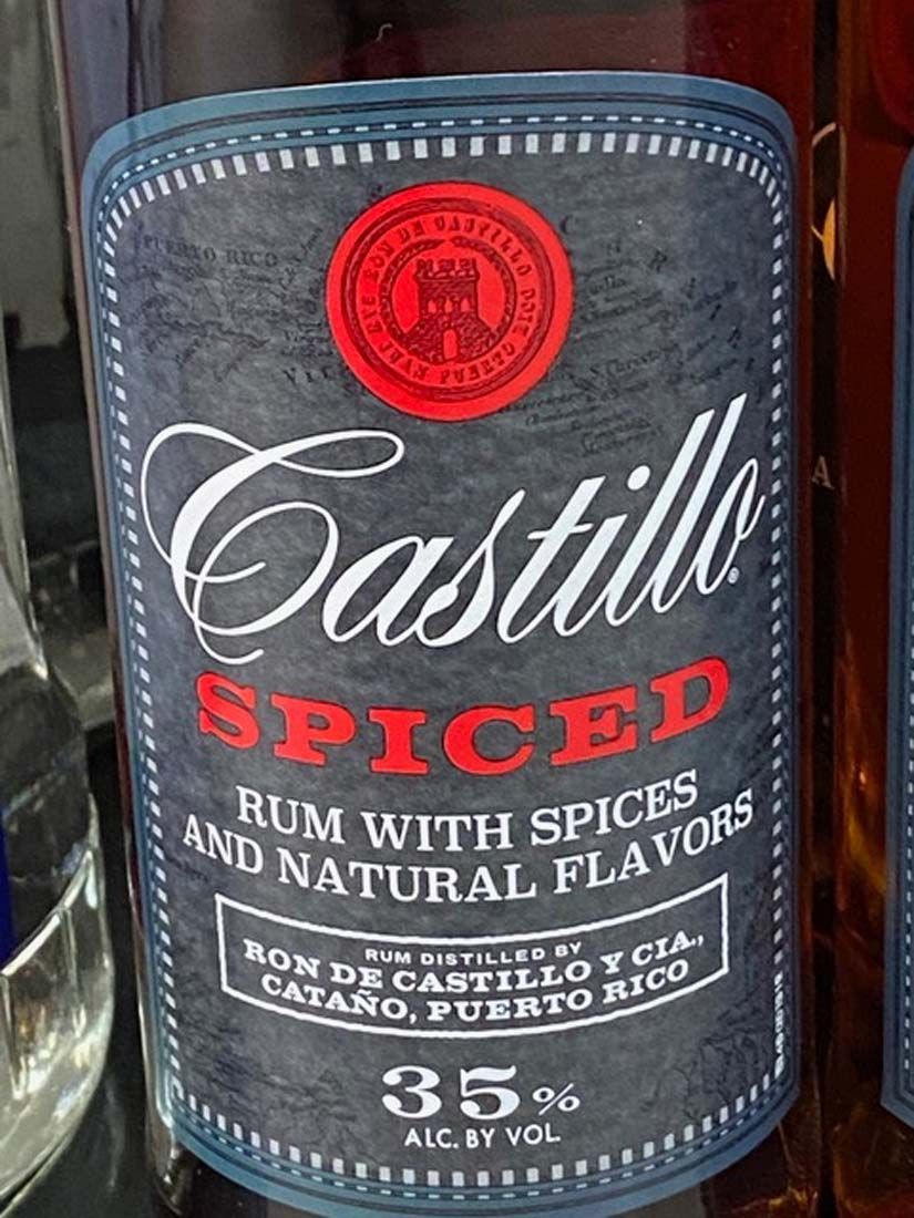A bottle of castillo spiced rum with spices and natural flavors