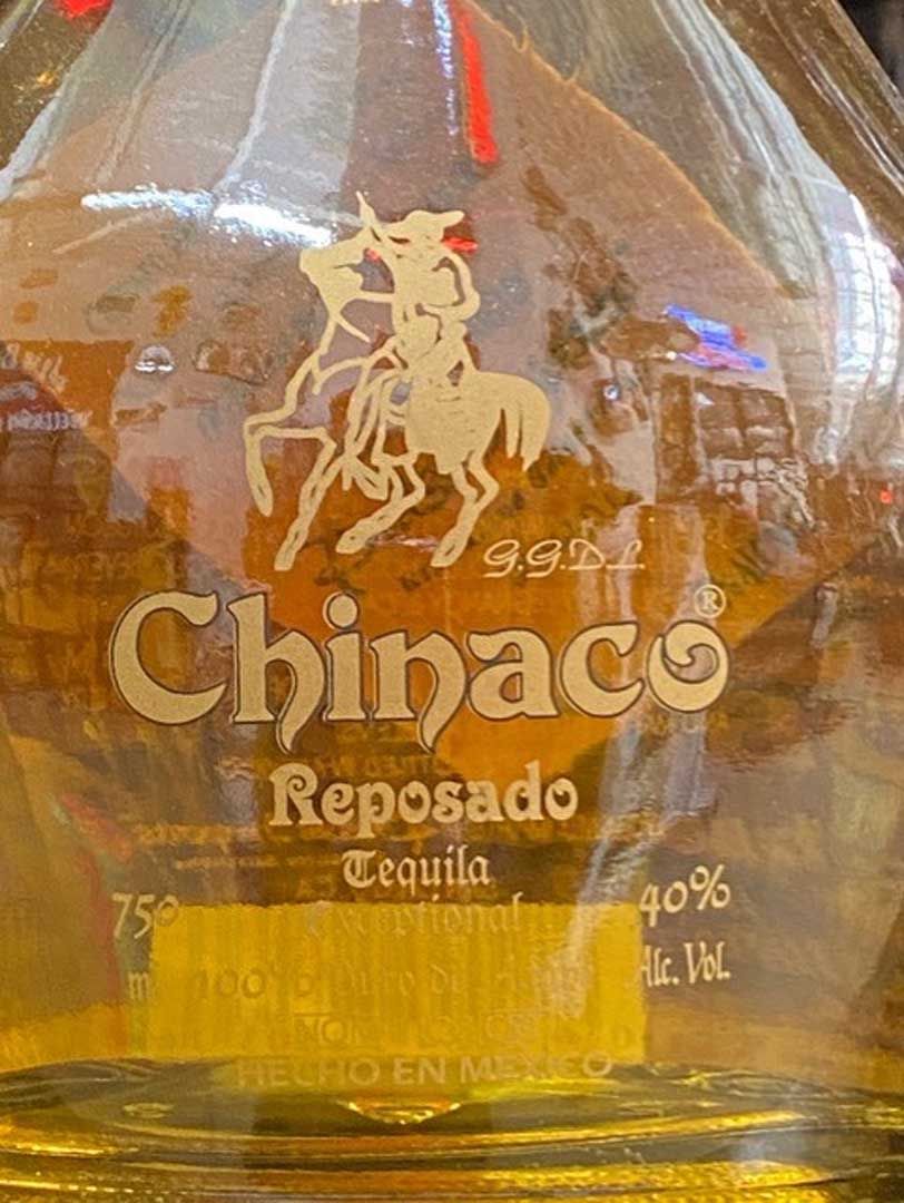 A close up of a bottle of chinaco reposado tequila