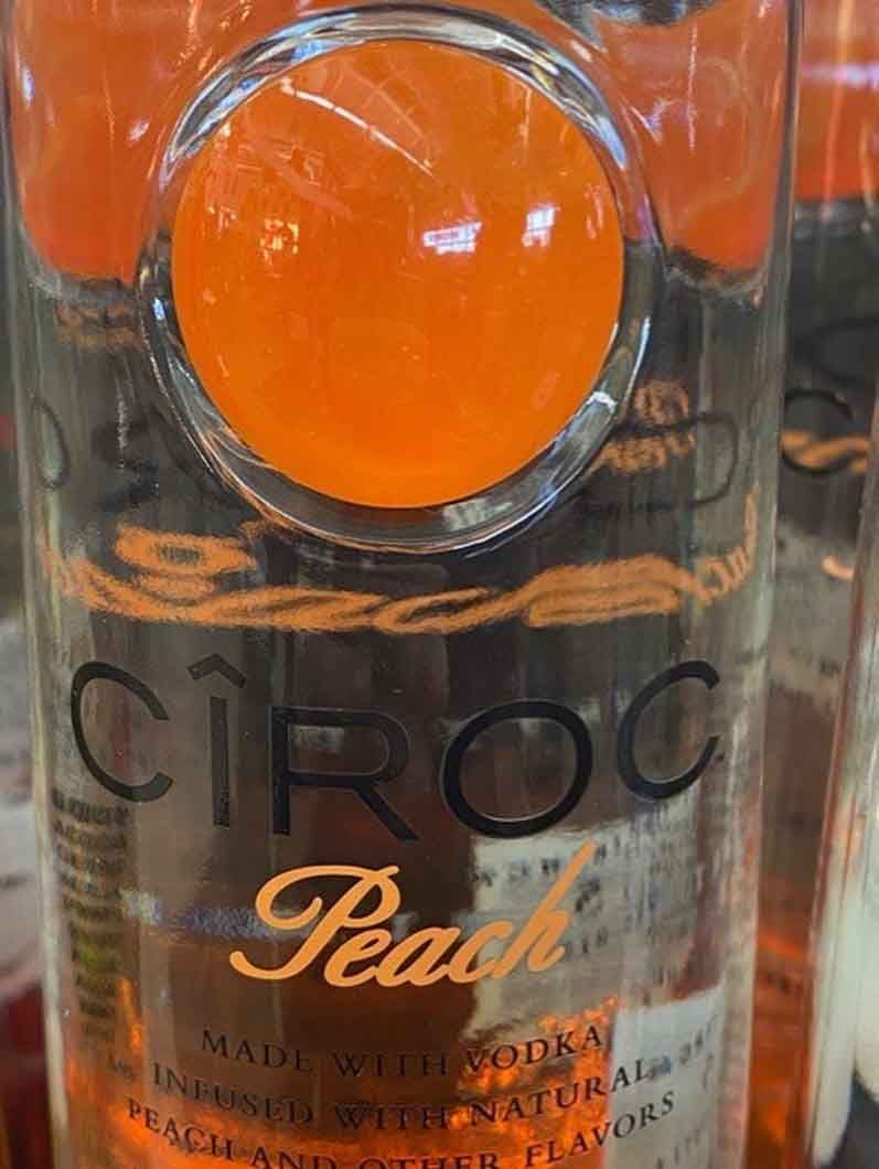 A close up of a bottle of ciroc peach vodka