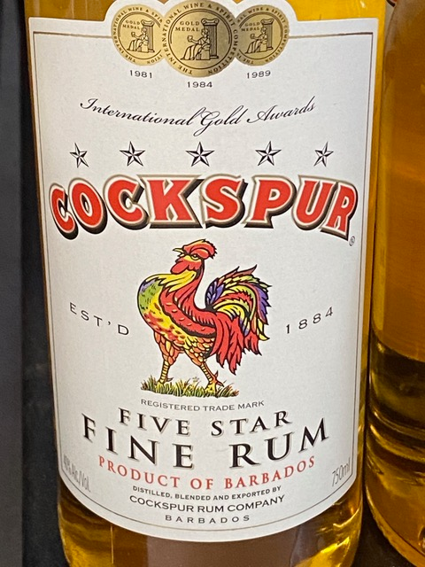A bottle of cockspur five star fine rum with a rooster on the label