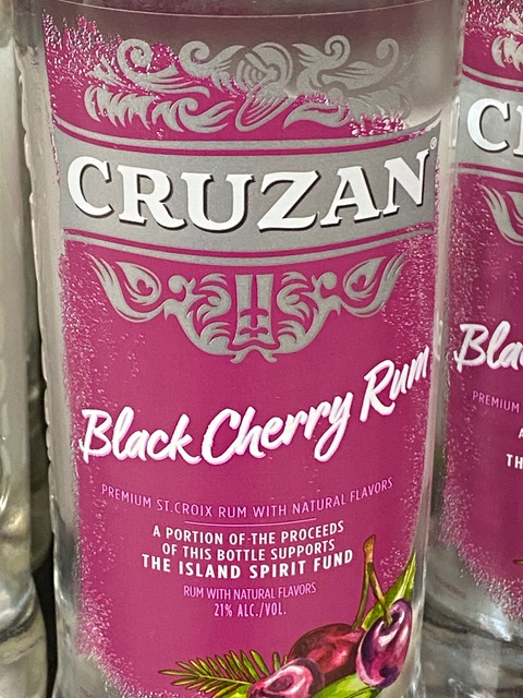 A close up of a bottle of cruzan black cherry rum