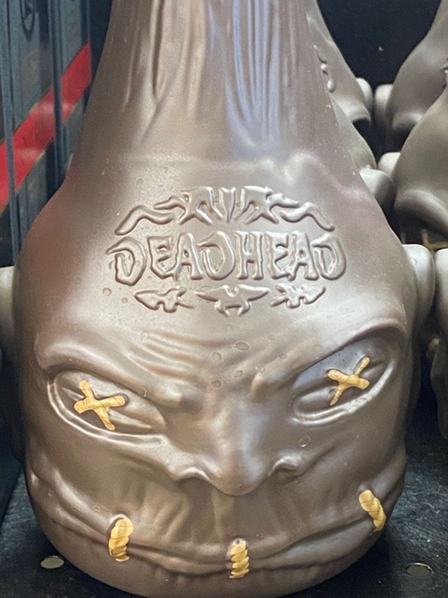A close up of a deadhead bottle with a face on it