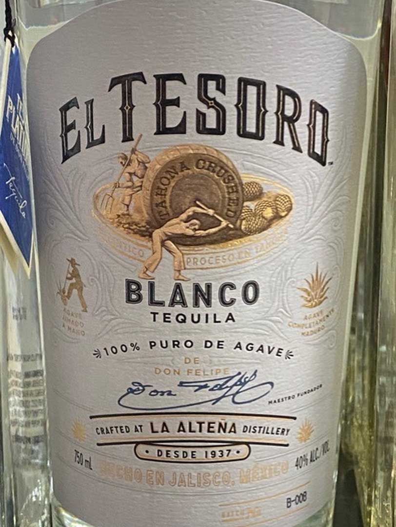 A close up of a bottle of el tesoro blanco tequila.