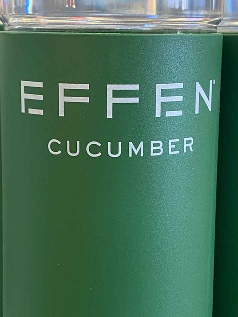 A green cup with the word cucumber on it.