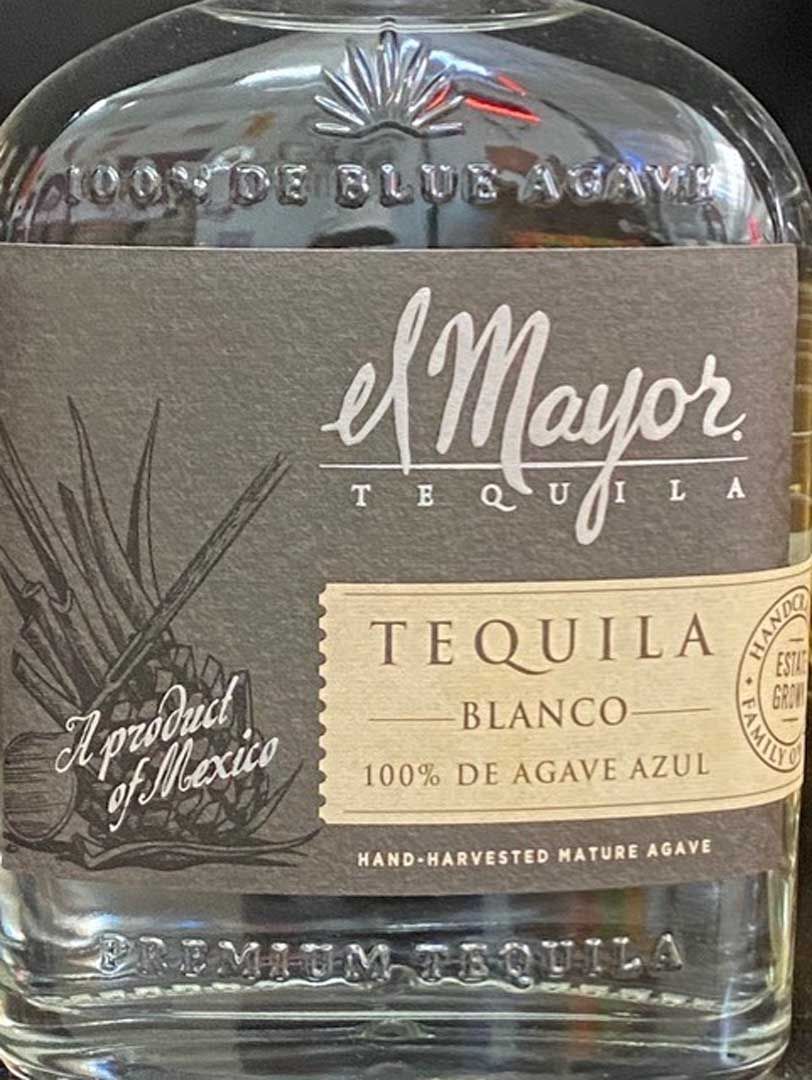 A bottle of el mayor tequila blanco is sitting on a table.