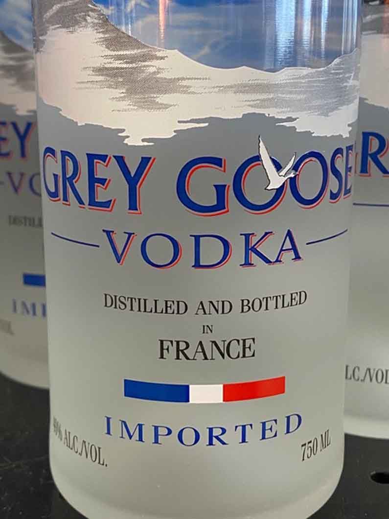 A close up of a bottle of grey goose vodka