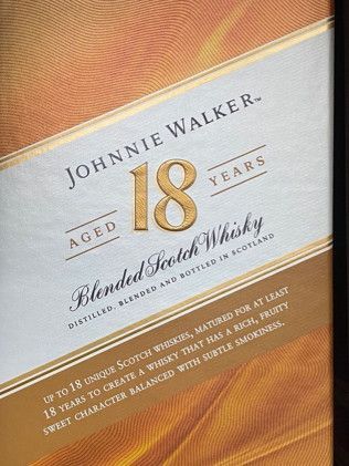 A close up of a bottle of johnnie walker aged 18 years blended scotch whisky.