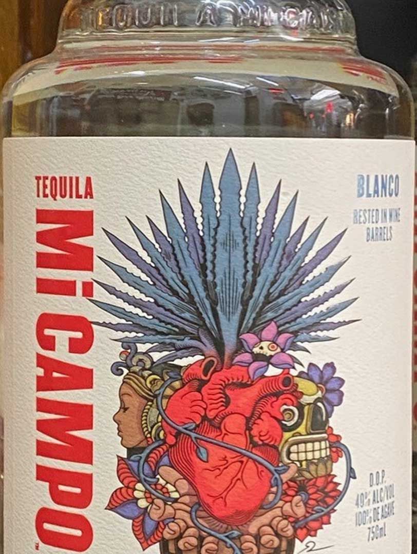A close up of a bottle of tequila with a heart on the label.