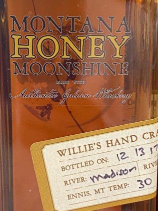 A bottle of montana honey moonshine with a label on it.
