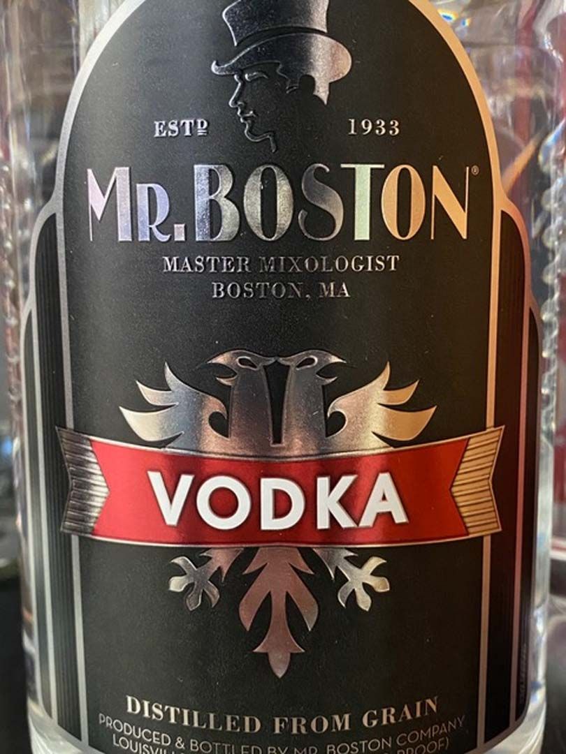 A bottle of mr. boston vodka is sitting on a table