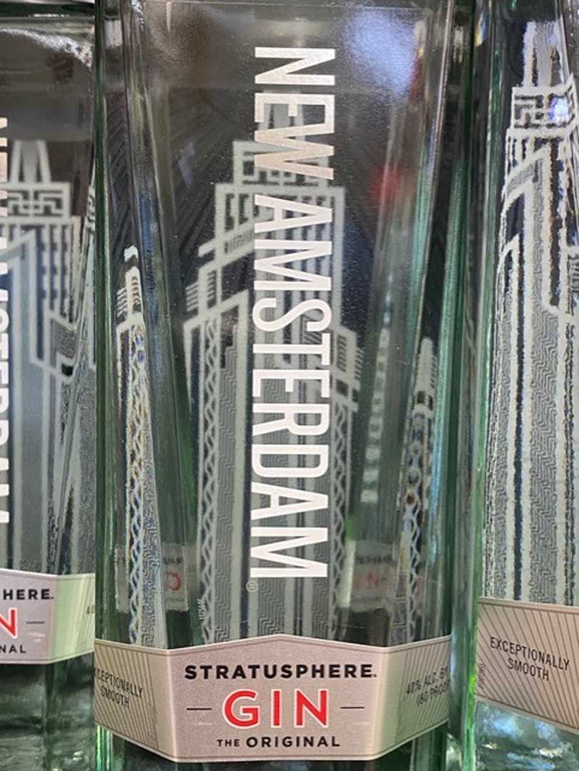 A bottle of new amsterdam stratosphere gin is sitting on a shelf.