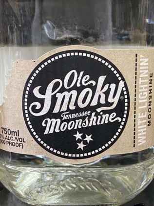 A close up of a bottle of ole smoky tennessee moonshine.