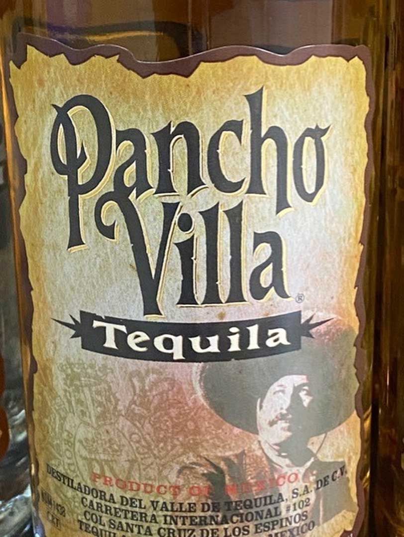 A bottle of pancho villa tequila with a cowboy on the label