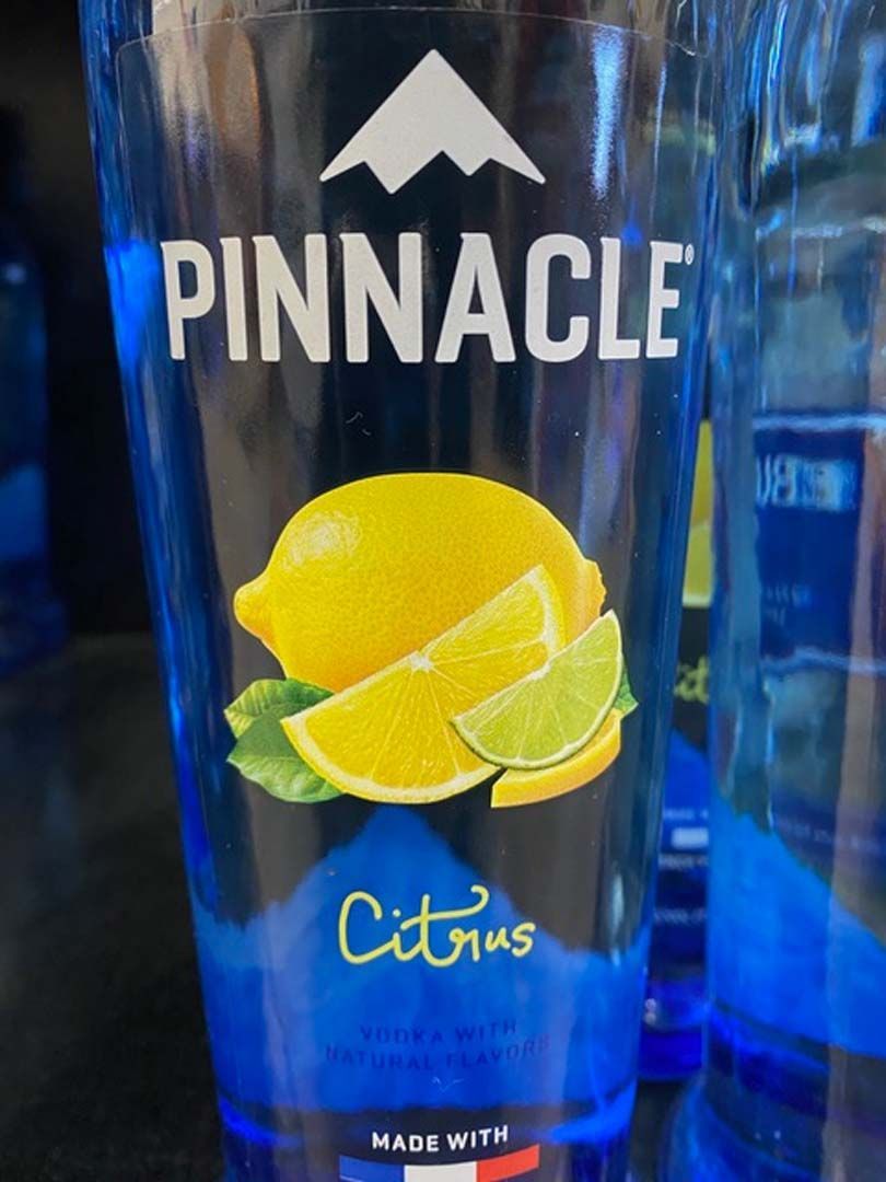 A bottle of pinnacle citrus vodka with a lemon and lime on the label