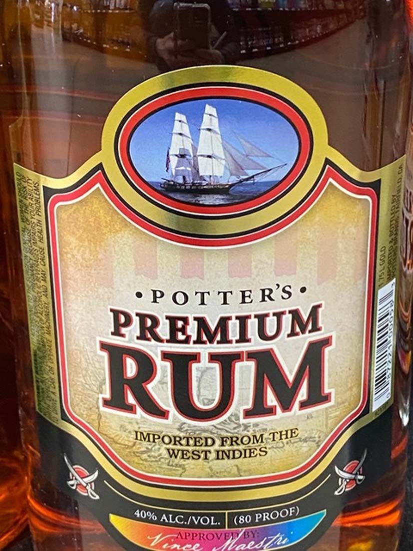 A close up of a bottle of potter 's premium rum