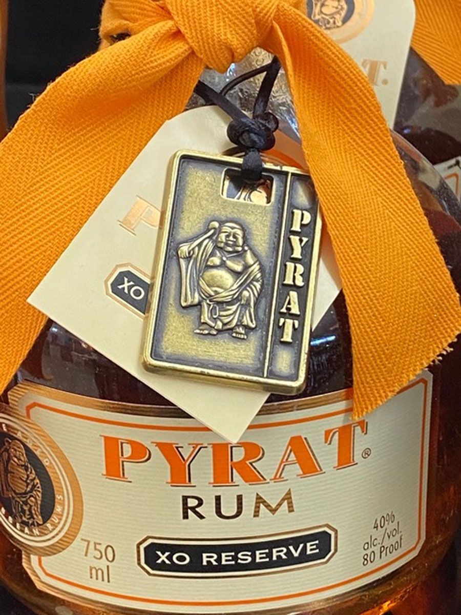 A bottle of pyrat rum with a tag on it