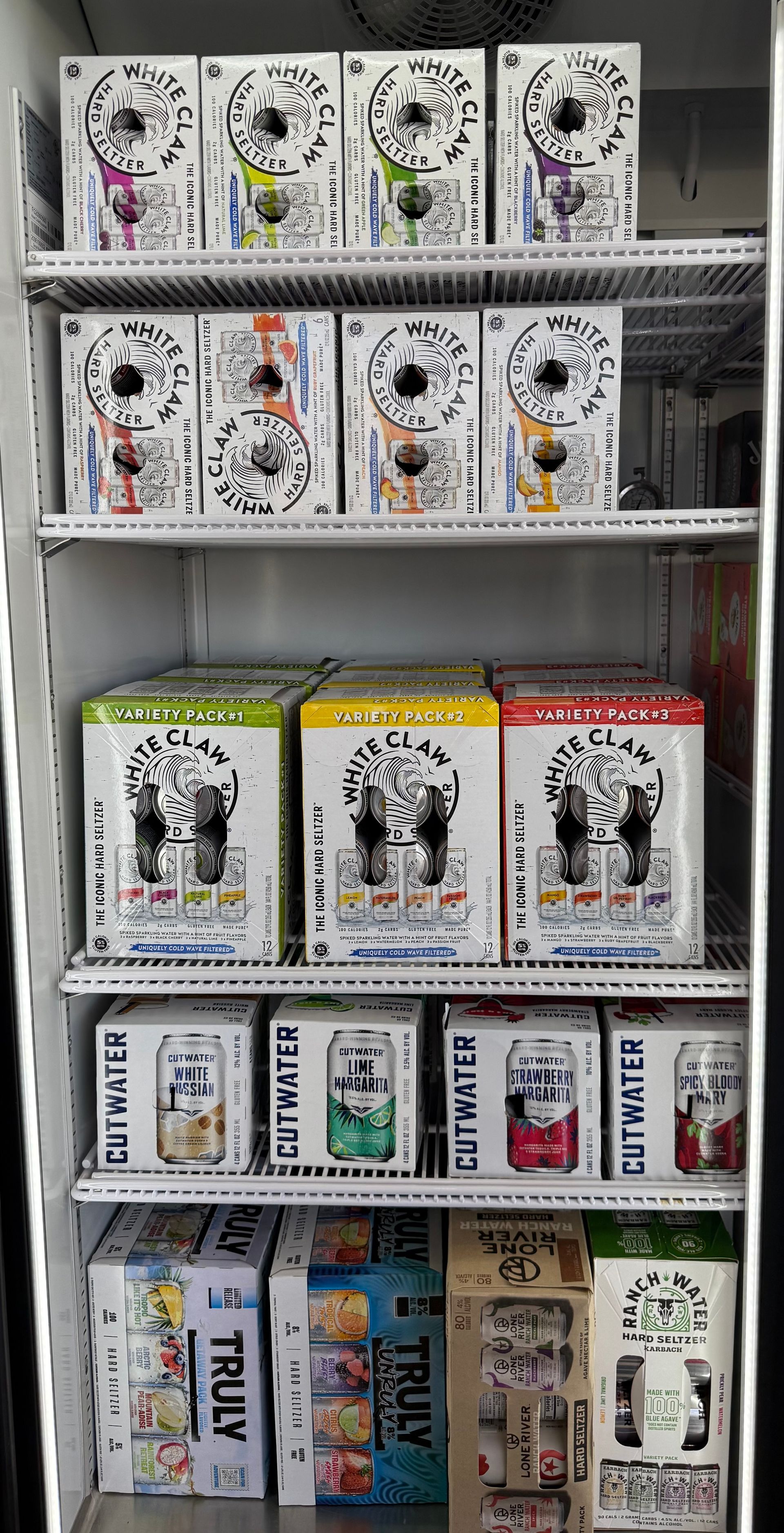 A refrigerator stocked with various flavors of Truly hard seltzer.