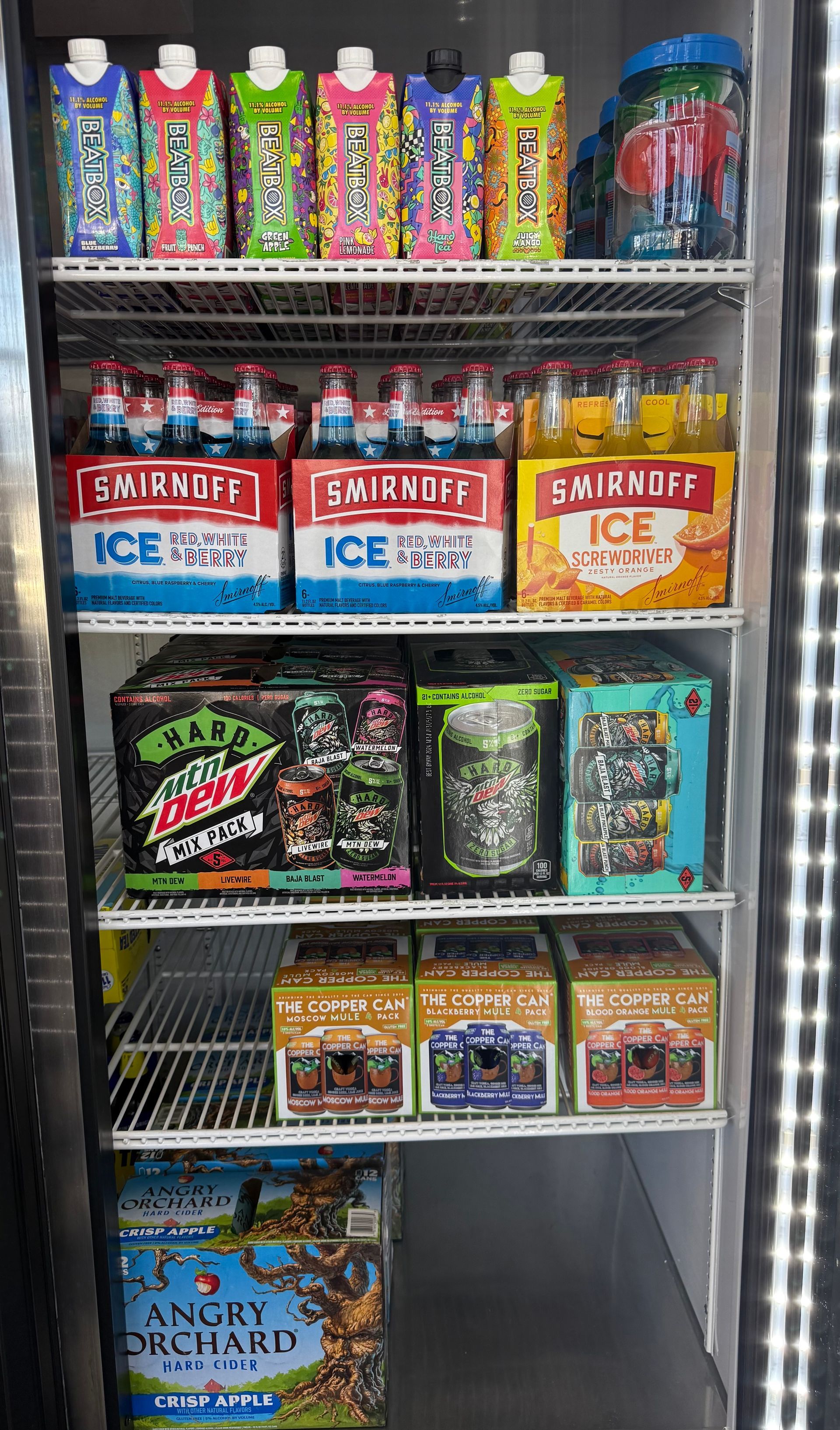 A refrigerator stocked with various alcoholic beverages and energy drinks.