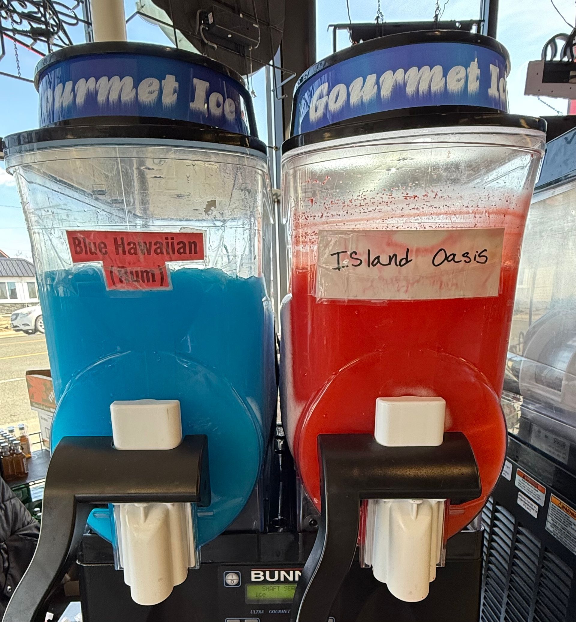 A close up of a strawberry juice dispenser