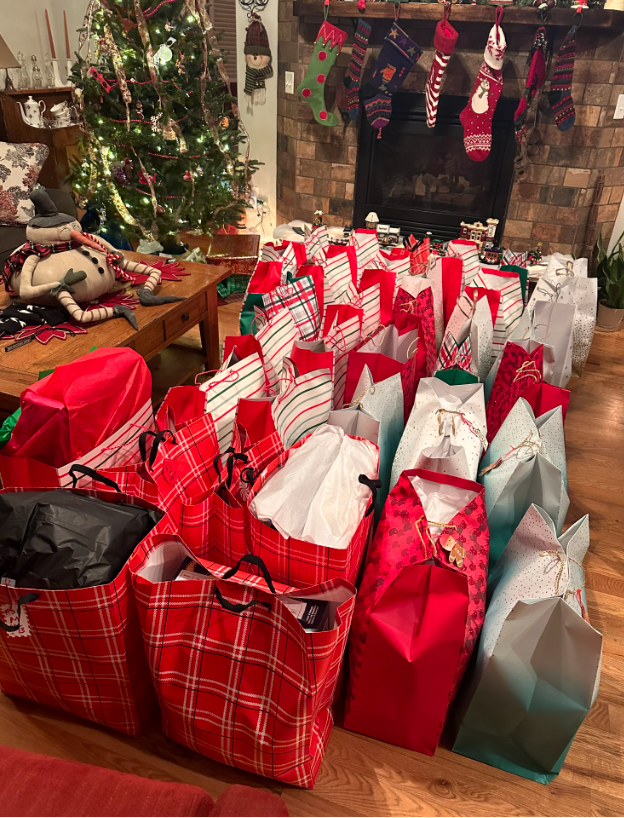A living room filled with lots of christmas presents and a christmas tree.