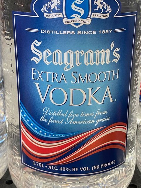 A bottle of seagram 's extra smooth vodka sits on a shelf