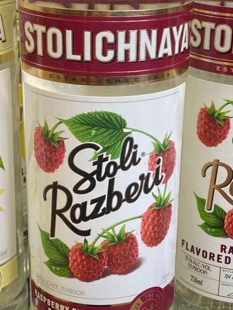 A bottle of stolichnaya vodka with raspberries on the label