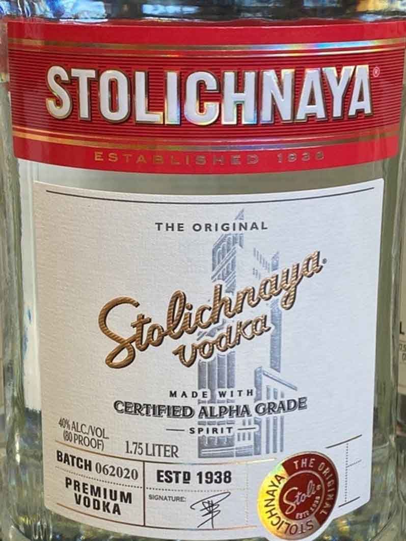A bottle of stolichnaya vodka is sitting on a table.