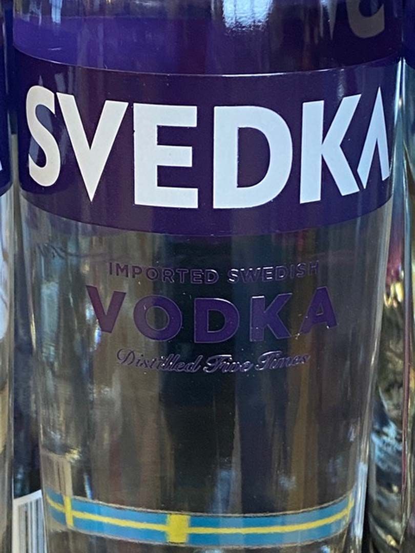 A bottle of svedka vodka is sitting on a table.