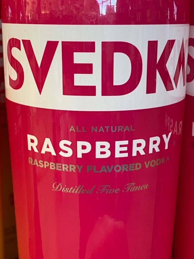 A pink bottle of svedka raspberry flavored vodka