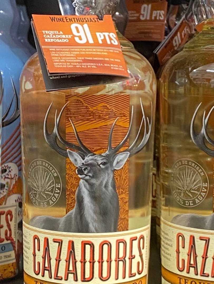 A bottle of cazadores tequila with a deer on the label