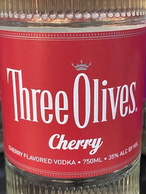 A bottle of three olives cherry flavored vodka