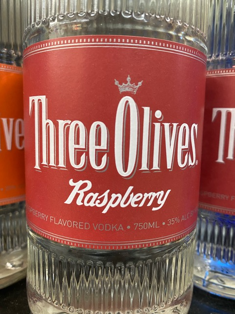 A bottle of three olives raspberry flavored vodka