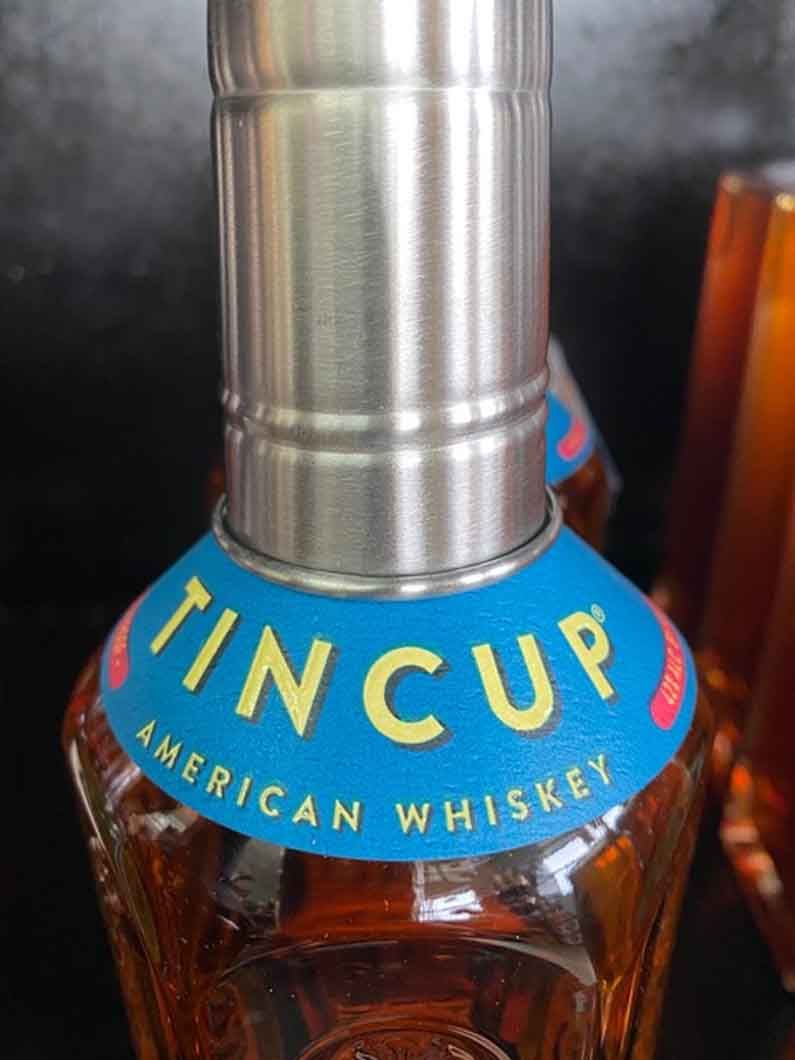 A close up of a bottle of tin cup american whiskey