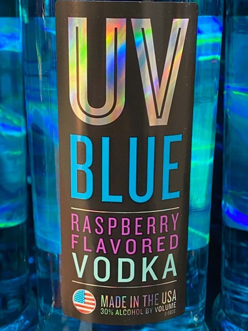 A bottle of uv blue raspberry flavored vodka made in the usa