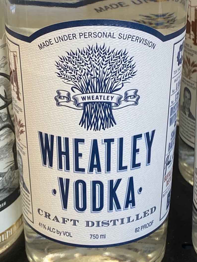 A bottle of wheatley vodka is sitting on a table.