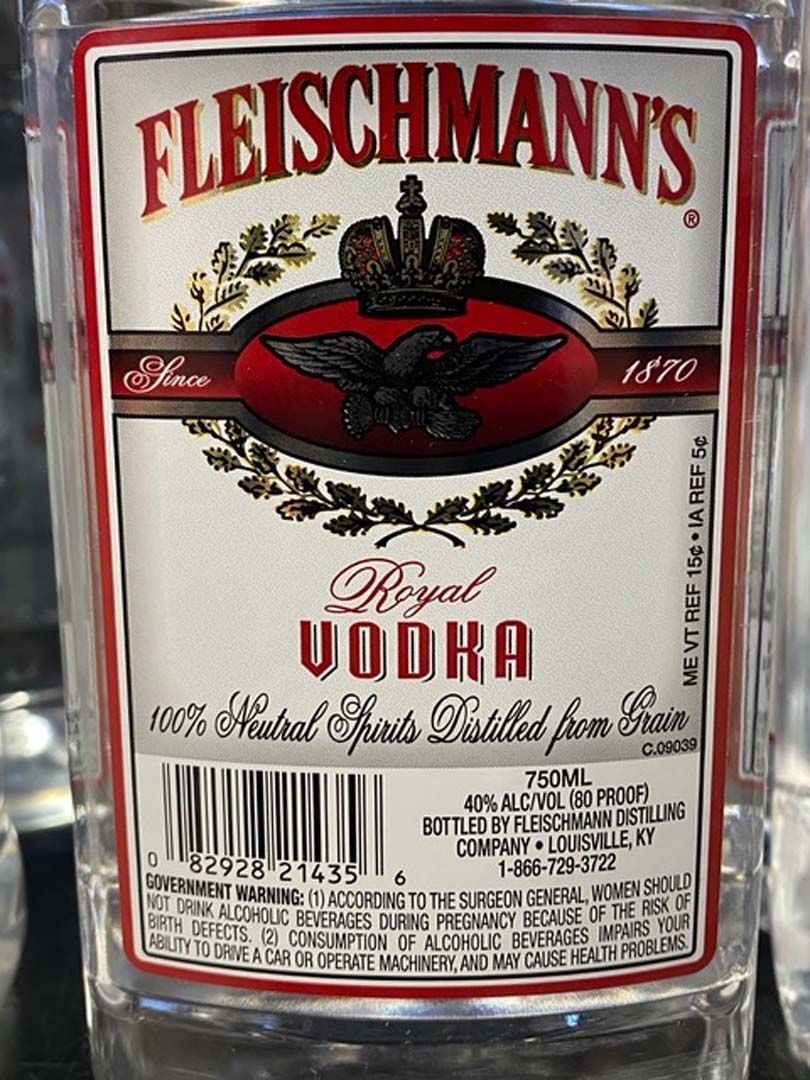 A bottle of fleischmann 's royal vodka is sitting on a table.