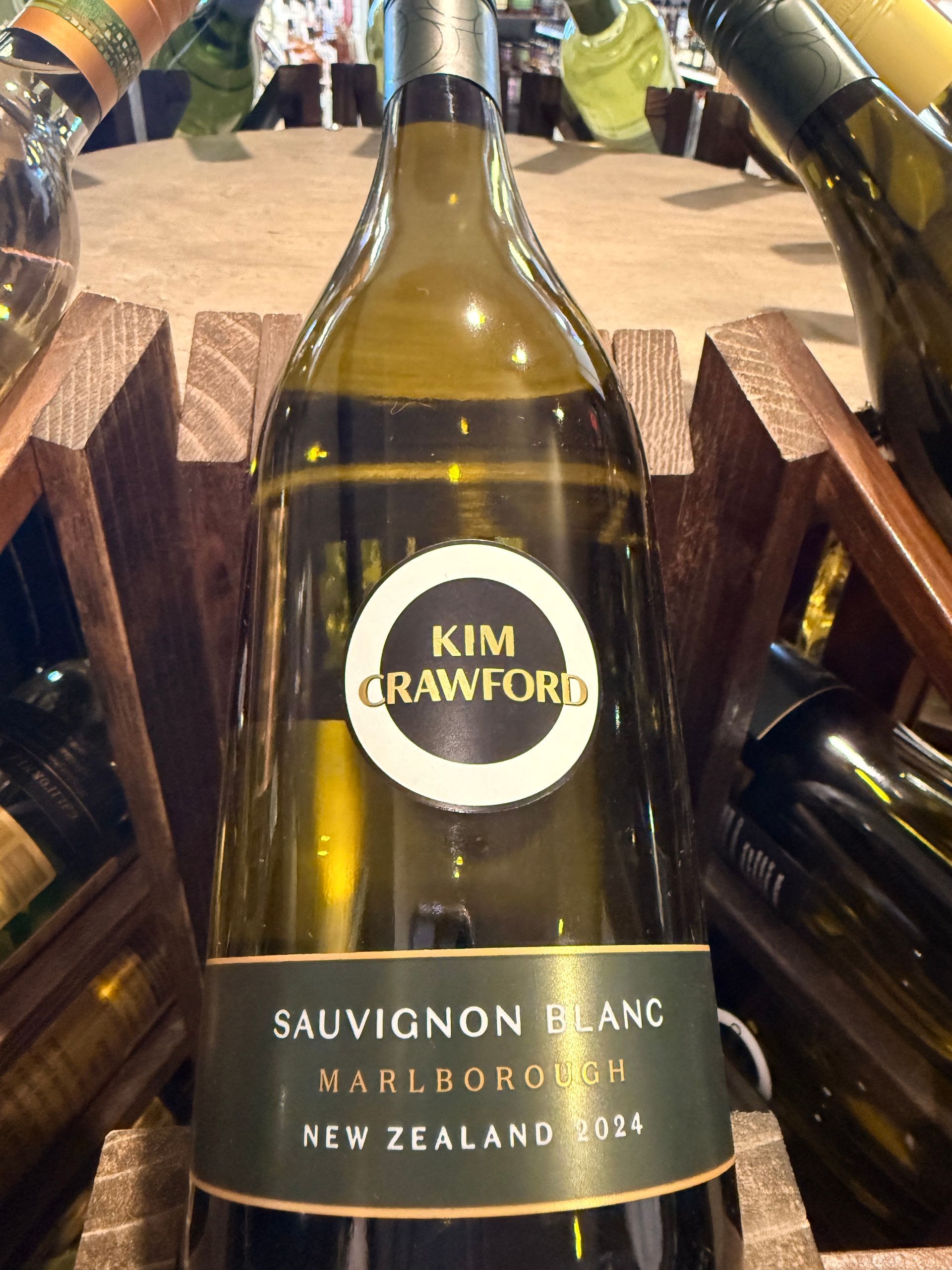 Bottle of Chateau Ste. Michelle wine in a wooden rack; label visible.